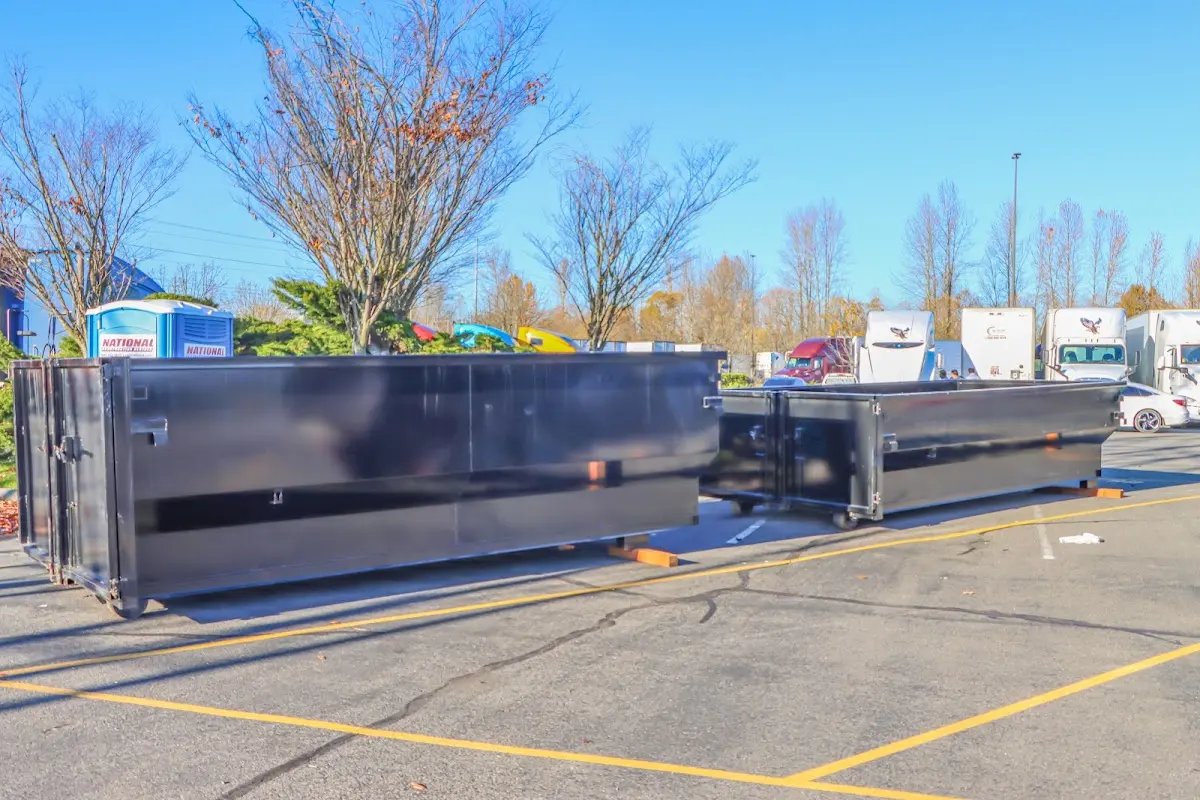 Professional dumpster rental service with roll-off container on residential driveway in Cottage Grove